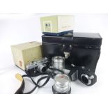 A Leica M4 DBP camera body serial No. 1180 476, together with three Leitz lenses (Elmar 1:2.