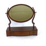 An Edwardian mahogany toilet mirror the oval bevelled glass over a three drawer base. h. 55 cm, w.