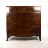 A 19th century mahogany bow fronted chest of two short over three long drawers with original turned
