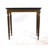 A gilt and black marble topped side table with Grecian key design to frieze on reeded legs. h.