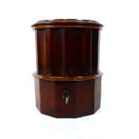 A Victorian mahogany circular commode with tooled leather insert to lift up top over accentuated