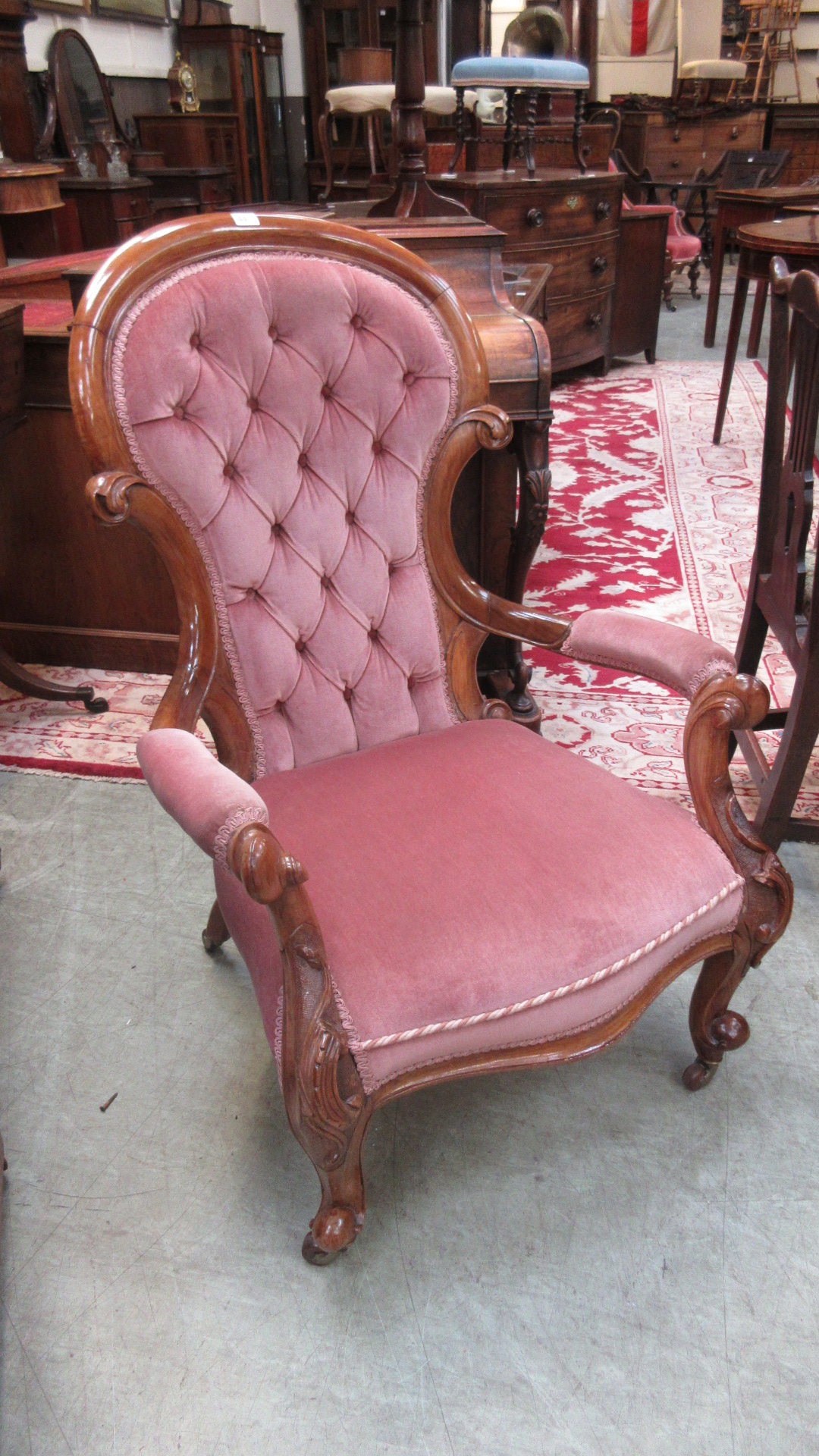 A Victorian walnut salon chair upholstered in a cut pink button backed fabric on carved cabriole - Image 2 of 5