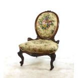 A Victorian walnut balloon back bedroom chair upholstered in floral print fabric on carved cabriole