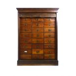 An Edwardian oak tambour fronted bank of twenty four drawers on plinth base. h. 116 cm, w. 86 cm, d.