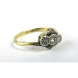 An 18ct yellow gold and platinum highlighted ring set five small diamonds in an illusion setting,