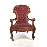 A Victorian walnut salon chair upholstered in a cut pink button backed fabric on carved cabriole