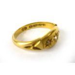 An 18ct yellow gold ring set three small graduated diamonds in recessed star settings,