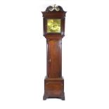 An 18th century oak longcase clock the swan neck pediment with eagle finial over the brass face