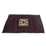 A handwoven Caucasian rug, with cream ground central lozenge incorporating bird motifs,