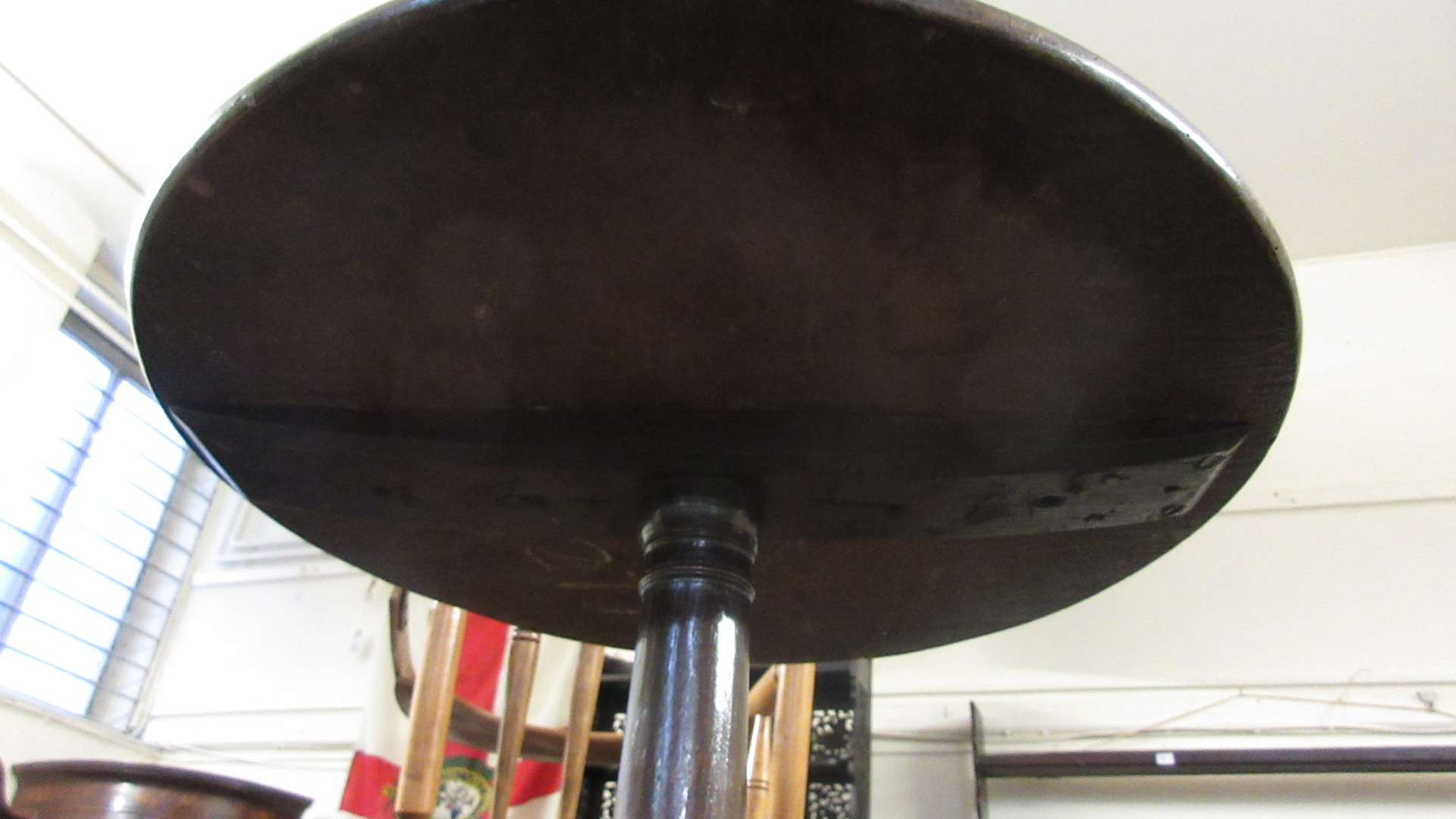 An 18th century oak and elm tripod table, the circular elm top on turned oak column. h. 69 cm, dia. - Image 3 of 3