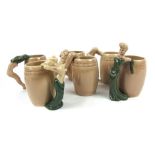 A set of six Dorothy Kindell striptease pottery mugs of barrel form,