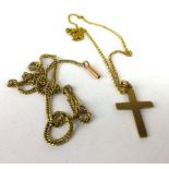 A 9ct yellow gold fine chainlink necklace suspending a 9ct yellow gold cross pendant,