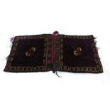 A handwoven Afghan saddle bag, the blue ground fields with central octagons,