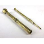 A yellow metal florally engraved propelling pencil by Mordan,