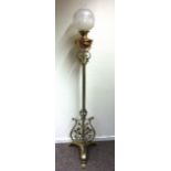 A late 19th century brass adjustable oil lamp stand with foliate design scrolls on tri form base. h.