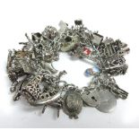 A silver bracelet suspending a large collection of charms