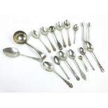 A mixed group of silver coffee spoons, a sauce ladle, a pair of sugar nips and other items,