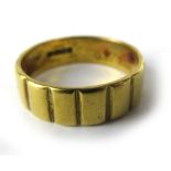 A 22ct yellow gold wedding band of ridge design, ring size P, 5.