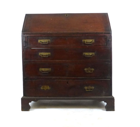 A George III mahogany bureau the fall front revealing a fitted interior over four graduated drawers