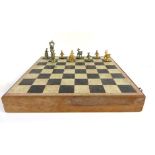 A marble and stoneware chessboard set in an oak hinge top surround containing carved stoneware