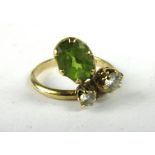 A 9ct yellow gold crossover ring set two graduated diamonds and an oval citrine, ring size P, 3.