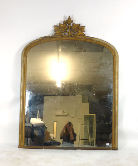 A 19th century gilt framed over mantle mirror with arched top and foliate carving. h. 161 cm, w.
