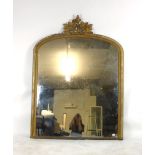 A 19th century gilt framed over mantle mirror with arched top and foliate carving. h. 161 cm, w.