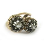 A 19th century yellow metal ring set old cut diamond cluster in a crossover setting, ring size S/T.