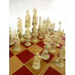 A late 19th century Chinese chess set, with turned ivory pieces on puzzle ball bases,