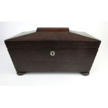 A regency sarcophagus shaped rosewood tea caddy with vacant interior on squat bun feet, h. 18 cm, w.