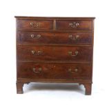 A late 18th century oak chest of two short over three long drawers on shaped bracket feet. h.