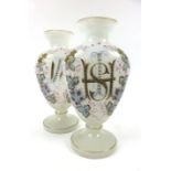 A pair of late 19th century opaline glass vases bearing a monogram within floral decoration, h. 27.