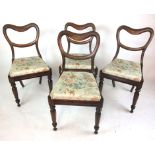 A set of four Victorian balloon back dining chairs with floral upholstery to the pad seats on