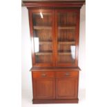 A late Victorian mahogany bookcase with two glazed doors enclosing three adjustable shelves above