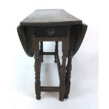 An early 18th century oak gate leg table with single drawer to end on turned legs with single gate