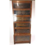 A four section oak Globe Wernicke sectional bookcase with two similar but unlabeled sections,