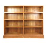 A Gordon Russell oak open bookcase dated 1928, with exposed dovetails and tenons,