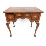 An early 18th century style walnut low boy, the quarter veneered,