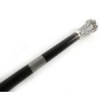 A Victorian ebonised sword stick with a silver hallmarked pommel handle top,