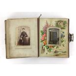 A leather bound musical Balmoral photo album containing various black and white photographs on a