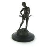 A modern bronze figure of Artemis, nude standing on deer holding a bow and arrow,