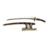 A Japanese miniature hand made katana letter opener with brass and strung decoration and a wooden