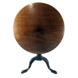 A late 18th century mahogany tilt top tripod table, the one piece top on urn turned column,