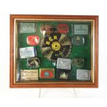 A framed and glazed display of various gramophone needles and needle tins,