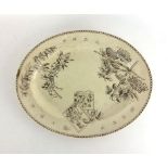 A 19th century English pottery platter decorated with Japanese script and plants,