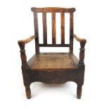 An 18th century oak and pine child's commode chair. h.55 cm, w.35 cm, d.