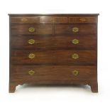 Am early 19th century mahogany chest of drawers the top over three secret drawers with marquetry