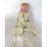 A German Armand Marseille ceramic headed doll with a full jointed composite body,