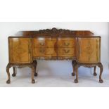 A reproduction 18th century style walnut sideboard the radial veneered top over two bow fronted