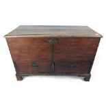 A late 18th century oak mule chest the lift up lid revealing a vacant interior above two short